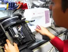 Vacuum repair technician servicing internal components on a workbench in Tuscaloosa, AL