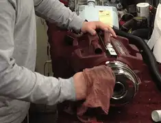 Vacuum repair technician cleaning and servicing a vacuum motor in Tuscaloosa, AL