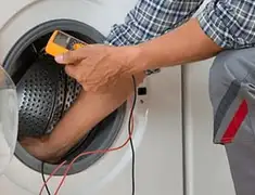 Washing machine repair technician testing a front-load washer with diagnostic tools in Tuscaloosa, AL